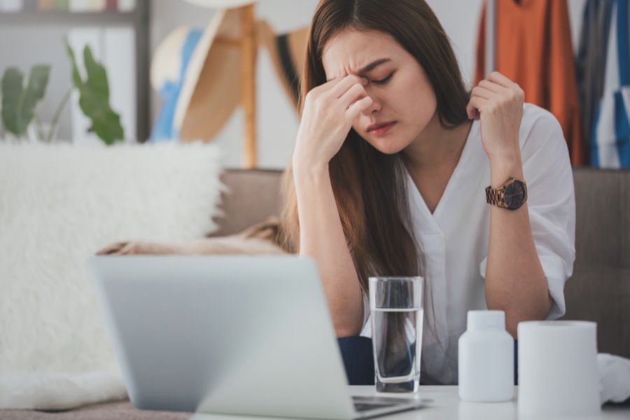 hungover woman drinking a glass of water